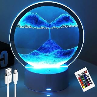 Real product photo – circular sand art LED lamp with USB cable and 16-colour remote control, showing blue flowing sand landscape